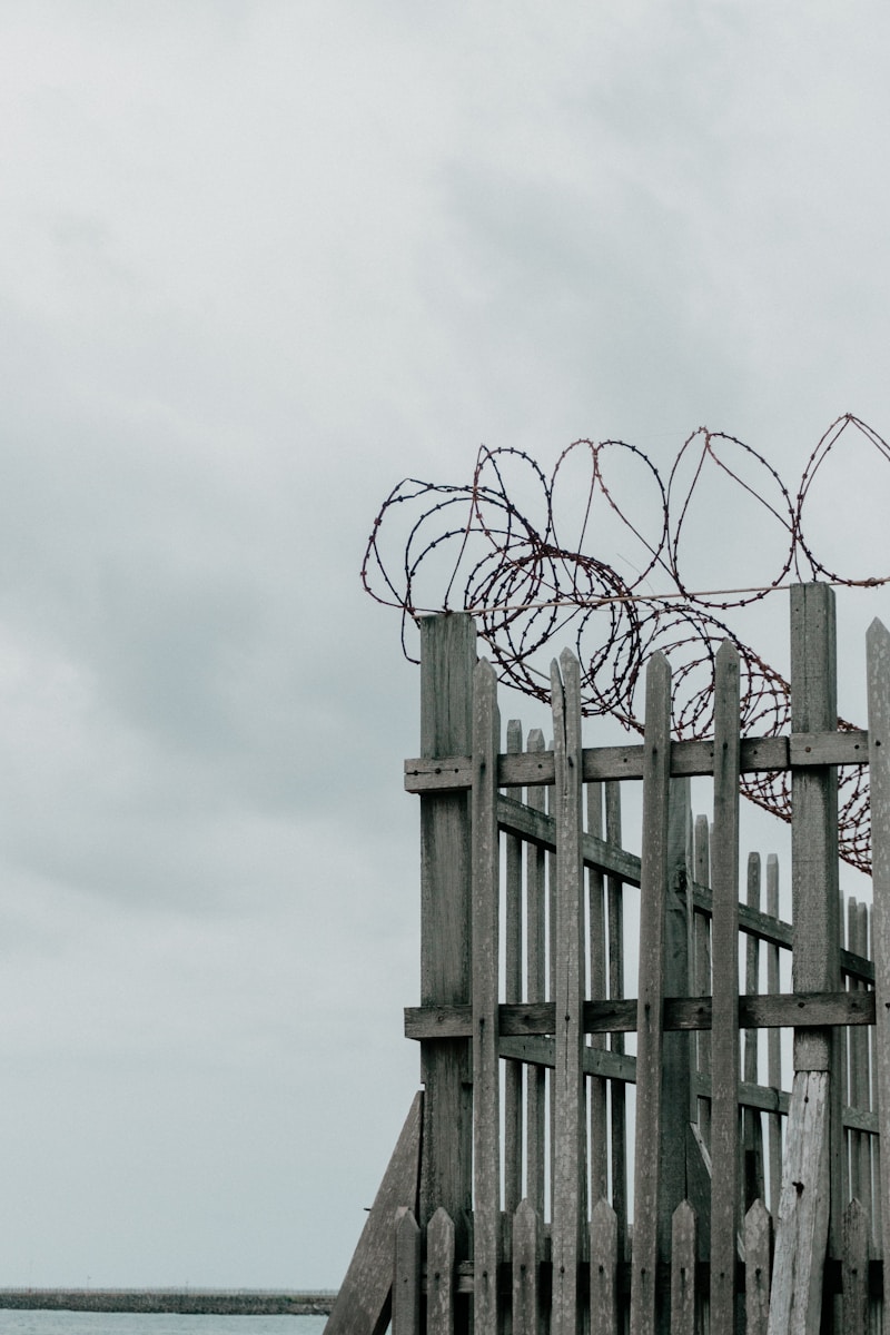 a wooden structure with barbed wire on top of it